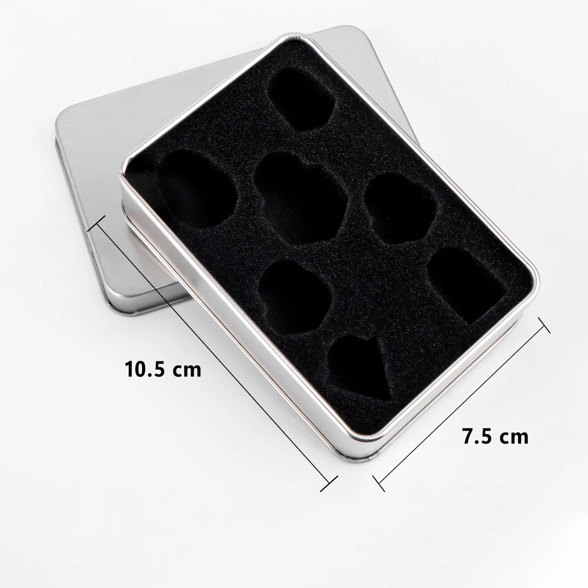 A silver plastic case holding a set of black resin polyhedral dice for tabletop gaming.