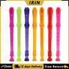 A set of five colored 8-hole soprano recorders with cleaning rods in pink, lime green, purple, orange, and red.