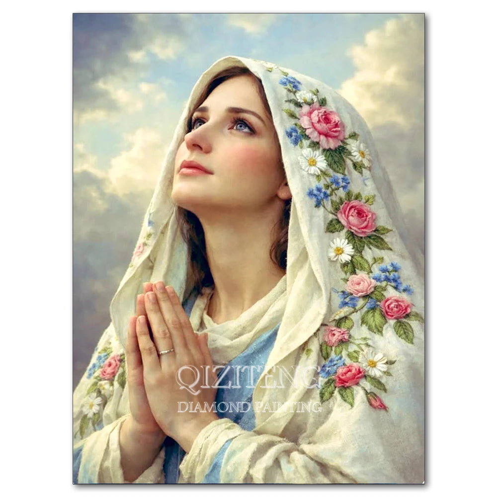 A woman wearing a white veil with pink and blue floral embroidery, looking upwards.