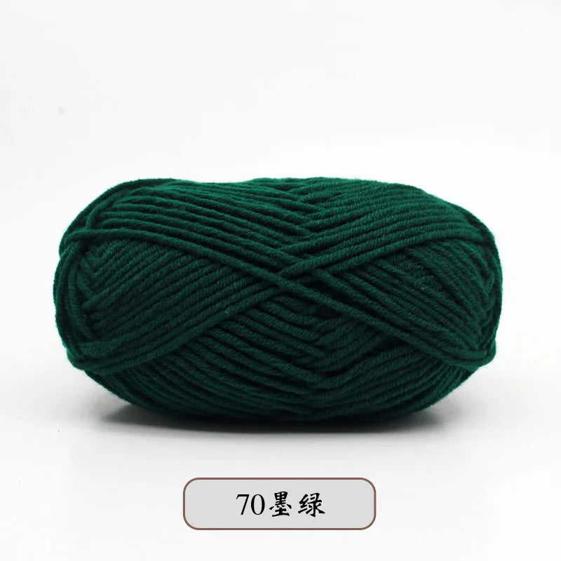 A ball of dark green pre-dyed milk cotton yarn, 70 skeins long.