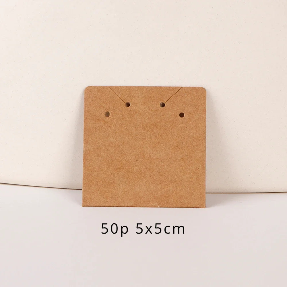 A square brown kraft card with two small holes is shown on a white background.