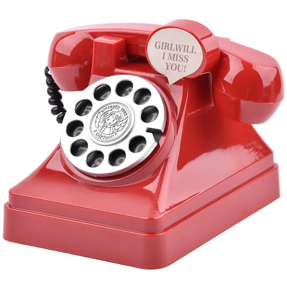 A vintage red rotary telephone piggy bank with a cutout saying Girlwill I miss you!