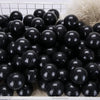 A pile of black glossy play balls for ball pits and games.