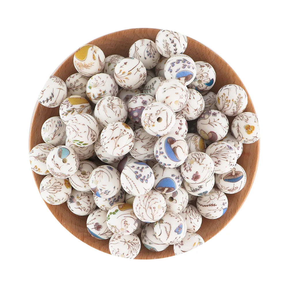 A pile of small, round silicone beads in various white and multicolored patterns is displayed in a wooden bowl.