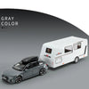 A gray diecast model of an RV camper truck is shown next to a white van model.