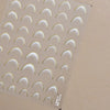 A sheet of 5D bronzing gothic nail art stickers with curved shapes.