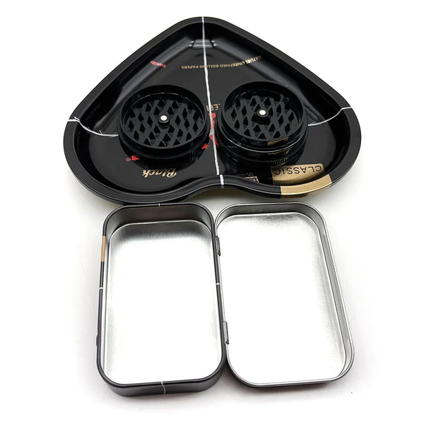 A black love-shaped metal rolling tray with a built-in herb grinder and a separate metal tray.
