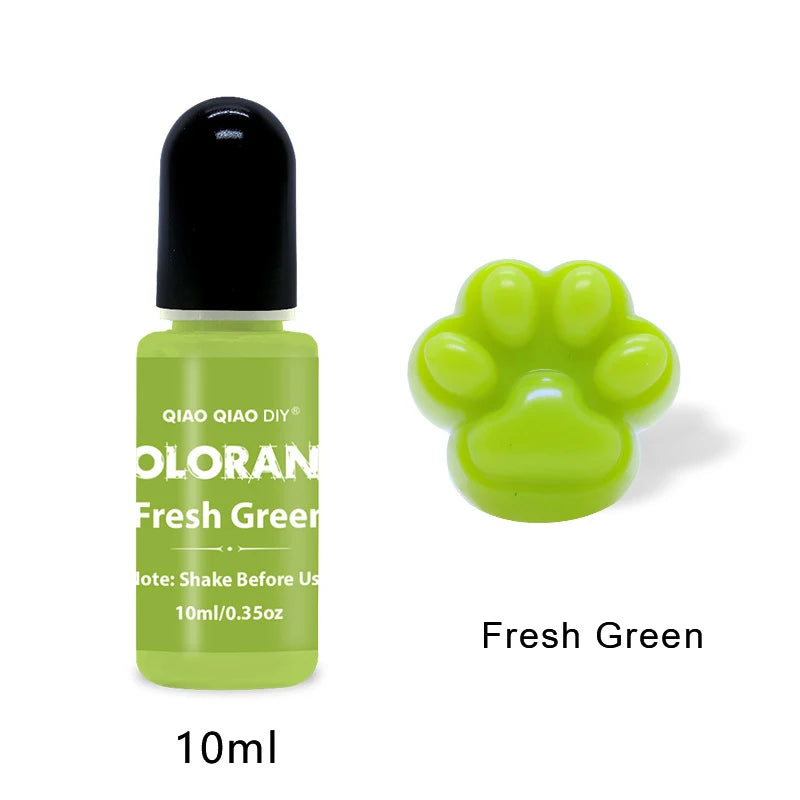 A small green bottle of Fresh Green liquid pigment with a black cap and a yellow paw print design.