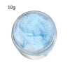 A clear jar filled with light blue adhesive flocking powder for jewelry making and crafts.