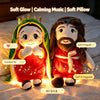 A plush doll resembling a biblical figure with a crown and beard, glowing warmly on a bed.