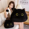 A woman is holding a large black cat plush toy and a smaller black cat plush toy on a white sofa.