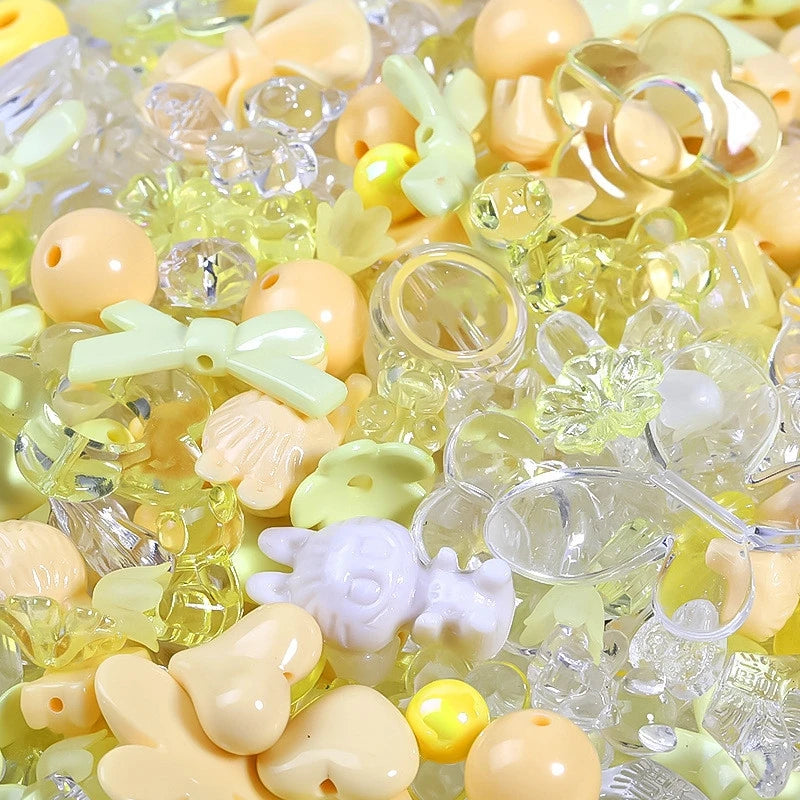 A close-up of mixed yellow and white acrylic loose beads for jewelry making