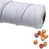 A roll of white natural cotton macrame rope used for crafts and decor.