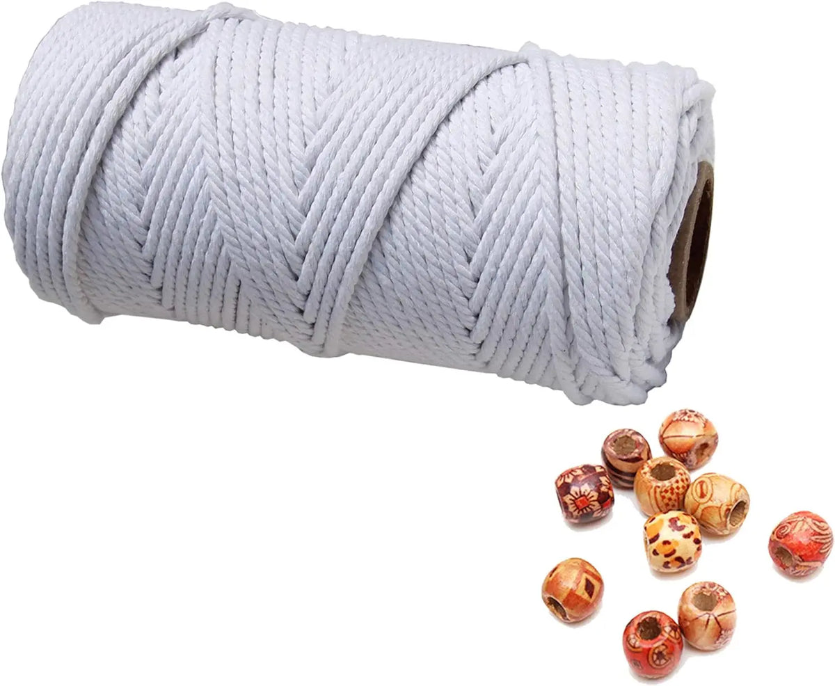 A roll of white natural cotton macrame rope used for crafts and decor.