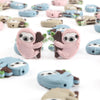 A collection of adorable sloth silicone beads in various shades of pink, blue, and beige for DIY crafts.