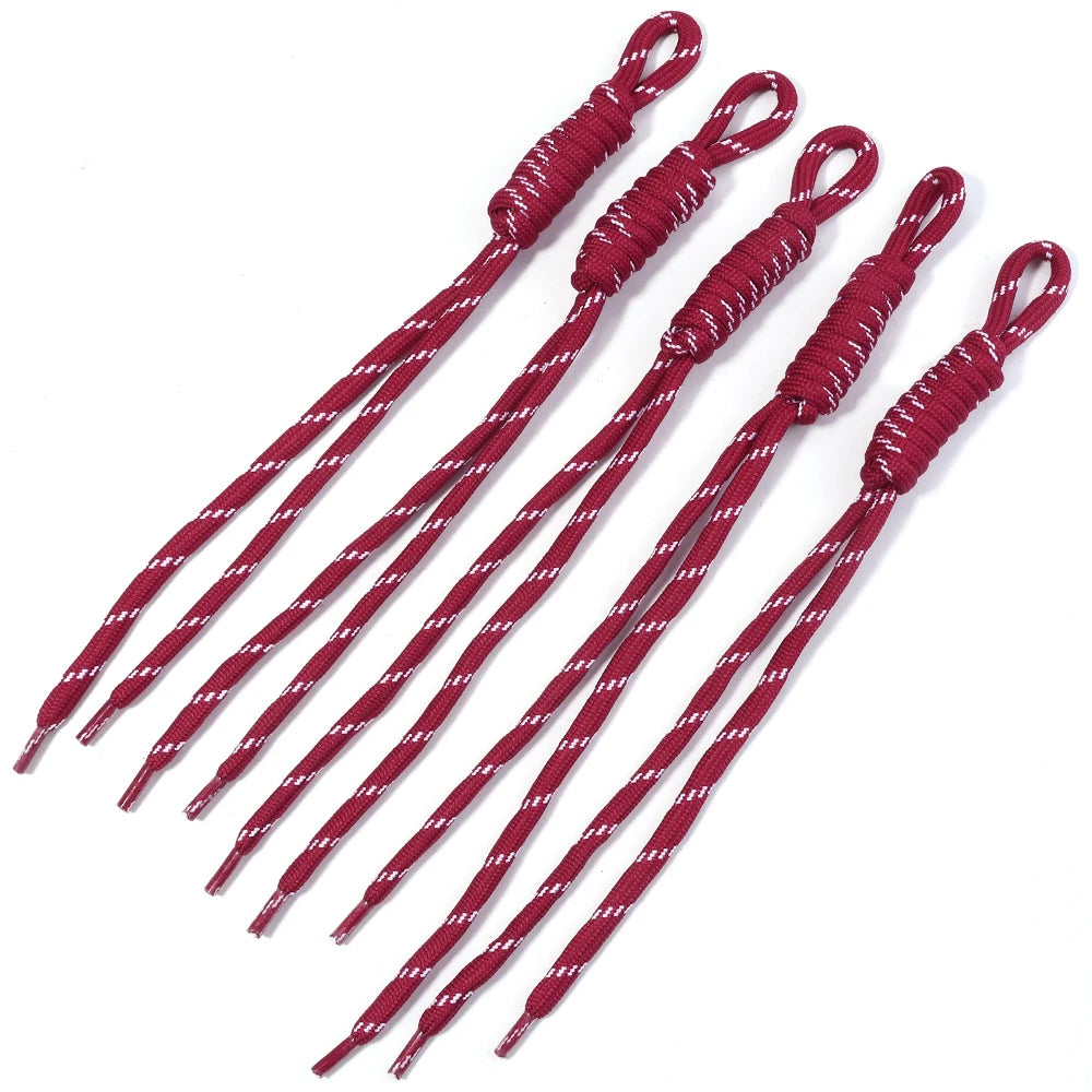 A set of red and white braided lanyards with keychains displayed diagonally.