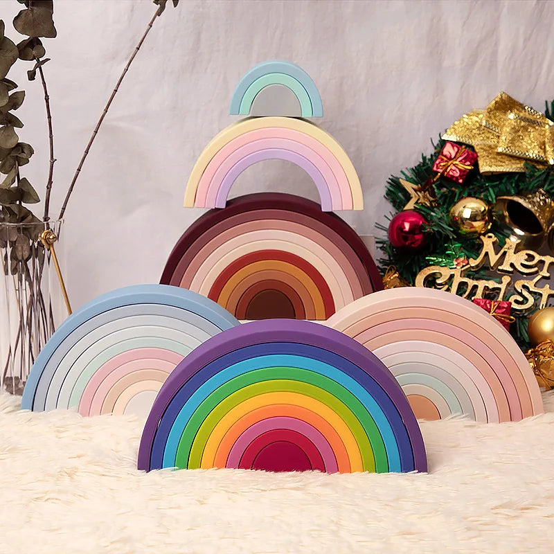 A colorful rainbow arch made of soft silicone building blocks displayed on a light surface.