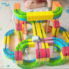 A colorful DIY magnetic track train set featuring flexible rail pieces and various colored plastic components.