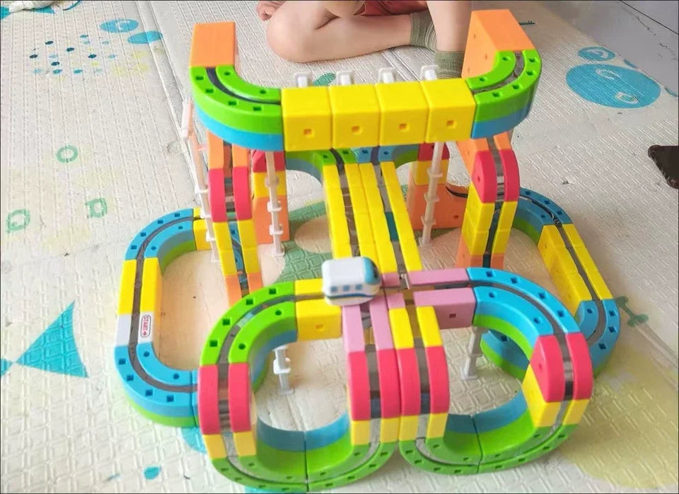 A colorful DIY magnetic track train set featuring flexible rail pieces and various colored plastic components.