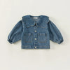 A blue denim jacket for kids featuring a ruffle collar and chest pockets.