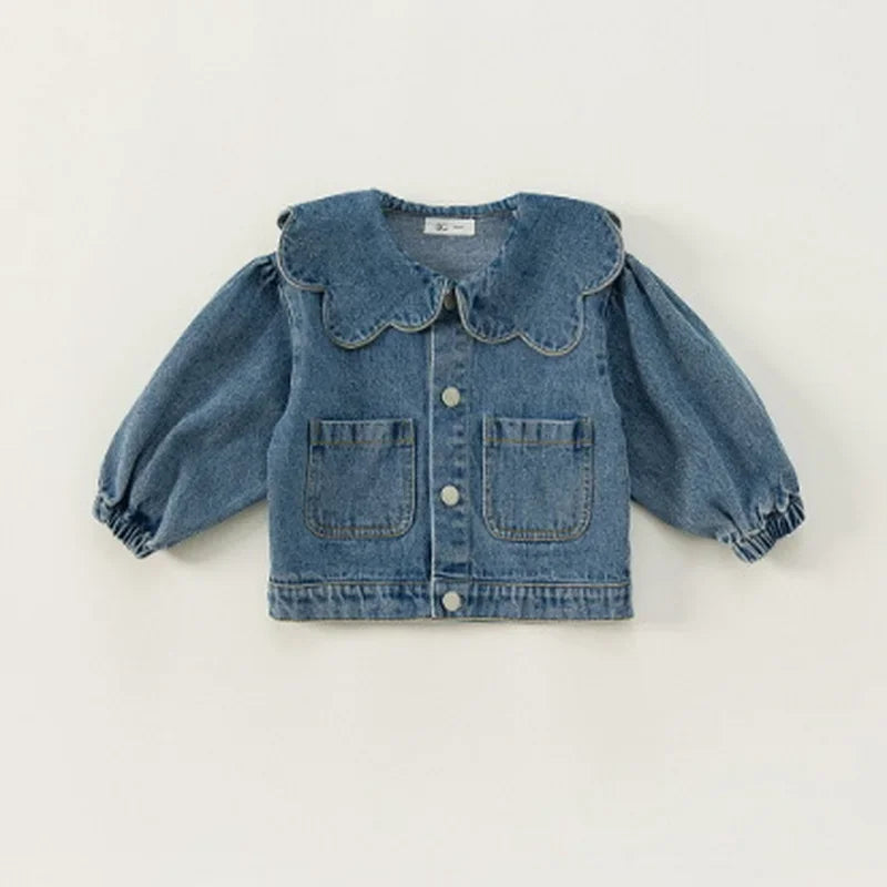 A blue denim jacket for kids featuring a ruffle collar and chest pockets.