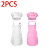 A set of two kids chef aprons and hats, one white and one pink.