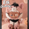 A fluffy pink and white plush figure resembling a cat face with dark features, displayed against a soft background.