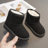 A pair of black, cozy fur-lined winter boots with a slip-on style shown being held by a hand.