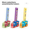 A set of colorful automatic domino train toys in pink, purple, and blue.