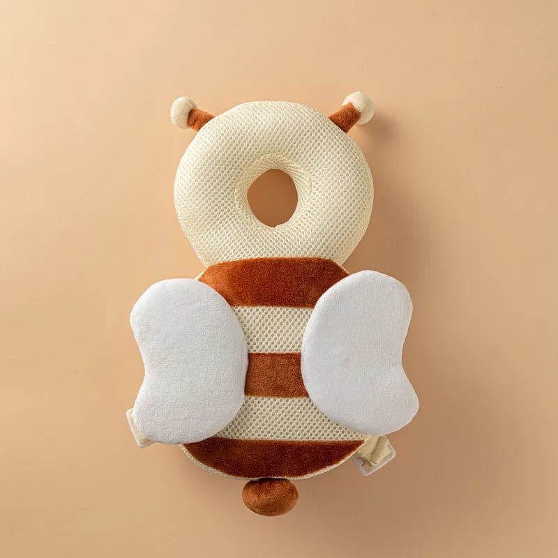 A soft baby head protector pillow shaped like a giraffe, featuring beige and brown stripes.