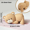A light tan bear cake topper is shown lying down and in a close-up view, measuring 4.6cm or 1.81in.
