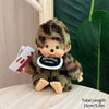 A fluffy brown and gray cartoon plush toy with a black collar and a small card next to it.