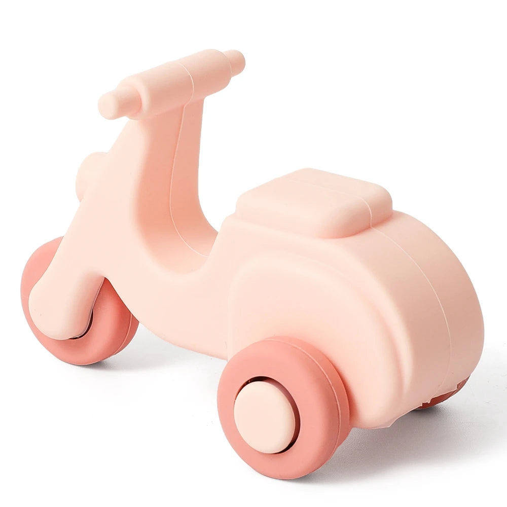A pink silicone toy car for toddlers, shown from the side.