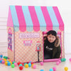 A pink and blue striped foldable kids play tent with a purple fabric front and a small decorative item.