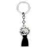Silver keychain featuring a black silhouette of a character with white hair and a black collar.