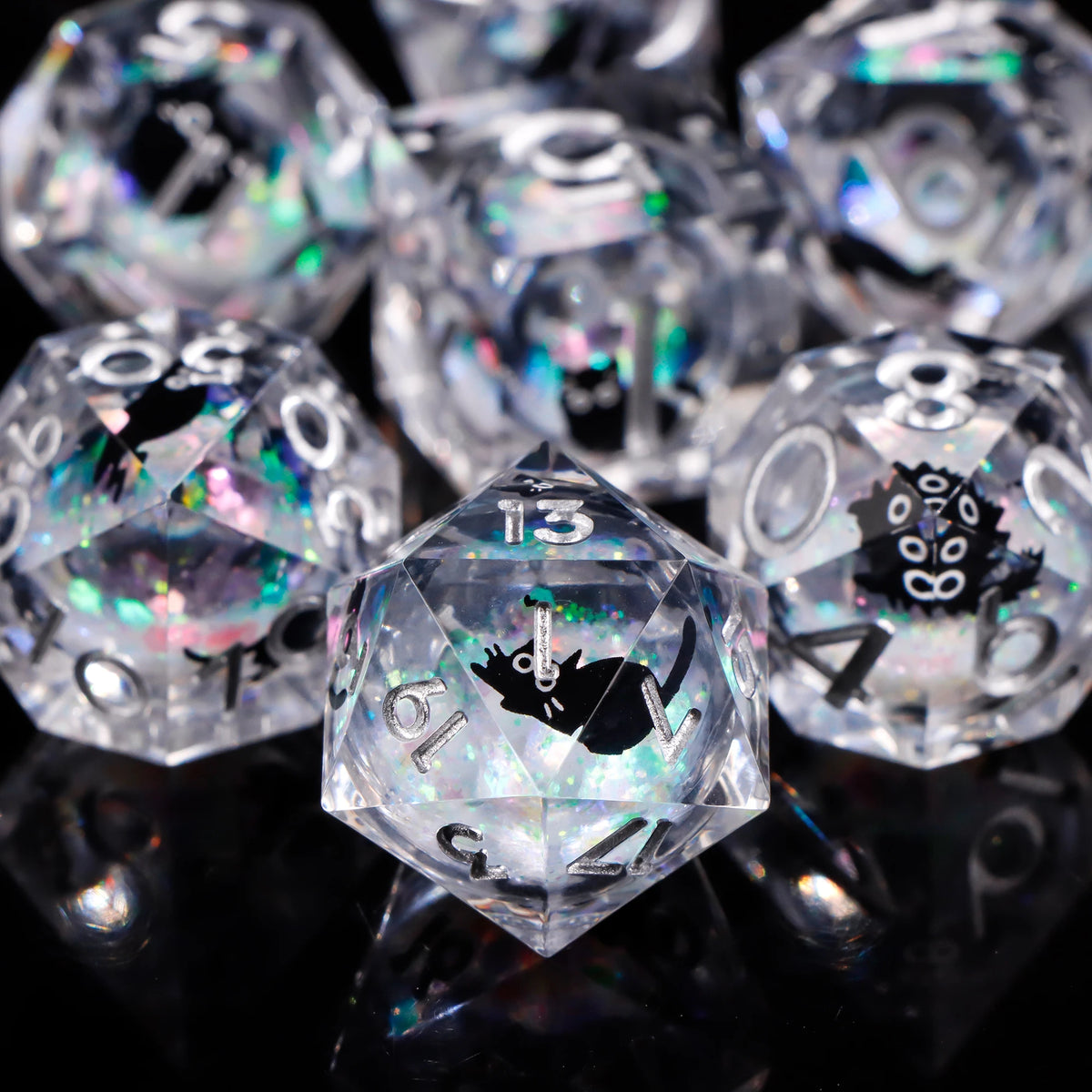 A close-up of a set of clear polyhedral dice, including a d10 and d8, reflecting light on a dark surface.