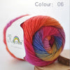 A ball of hand-dyed rainbow merino wool yarn in color 06, ready for knitting or crochet.