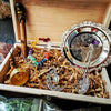 A wooden box contains a witchcraft starter kit with crystals, herbs, and a silver bowl.