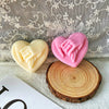 Pink silicone heart-shaped mold resting on a wooden slice with a lace background.