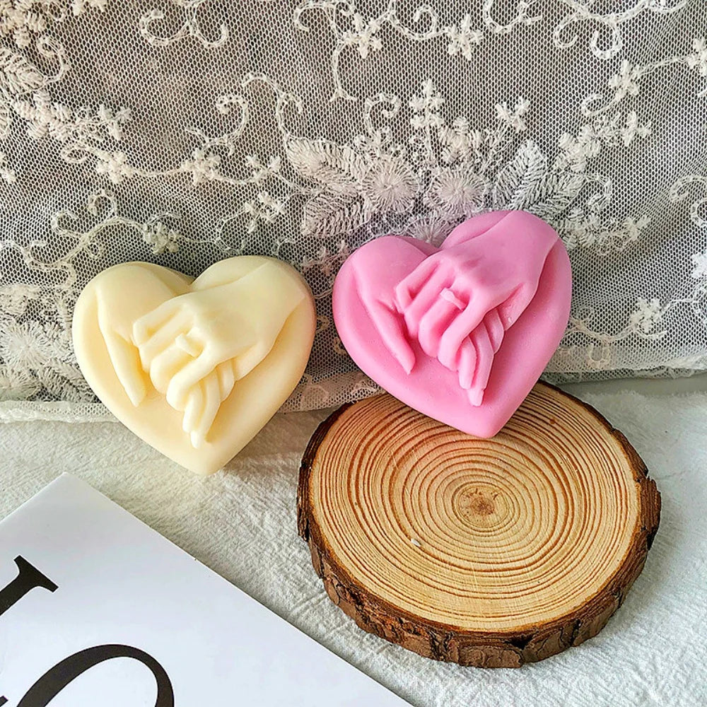 Pink silicone heart-shaped mold resting on a wooden slice with a lace background.