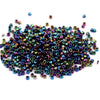 A pile of small metallic glass beads in various iridescent colors for jewelry making