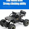 A black four-wheel drive off-road RC truck with large tires and a roll cage is shown against a white background.