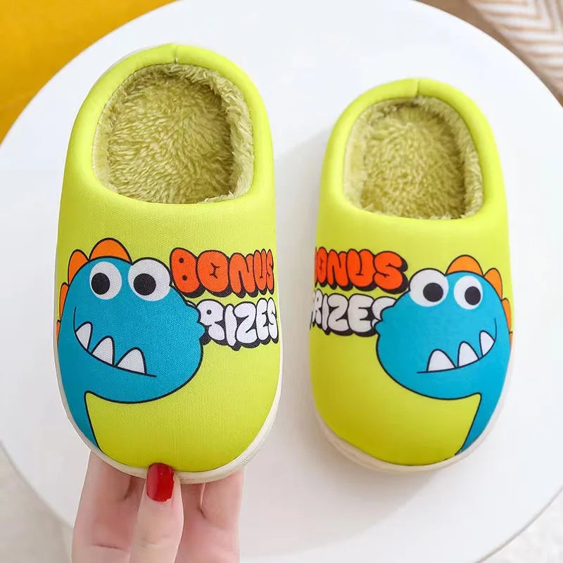 A pair of yellow dinosaur plush slippers with light green lining are shown on a white plate.