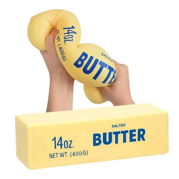 Eine Hand drückt ein gelbes, butterförmiges Entspannungstier mit der Aufschrift 14oz gesalzene Butter.