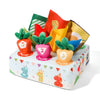 A colorful sensory toy box featuring soft pulling carrot toys in various shades of orange, green, and yellow.