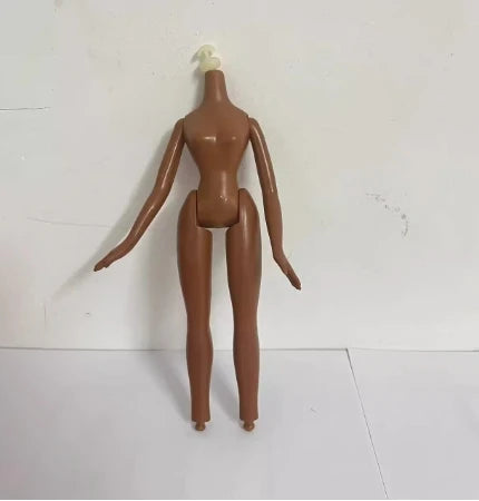 A brown fashion doll with a white hairpiece standing against a white background.