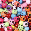A close-up view of various colorful rhinestone acrylic spacer beads in various shapes and sizes.