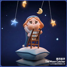 A figurine of a crying girl with blue hair and a blue dress is perched on a cloud, with crescent moon and star charms hanging