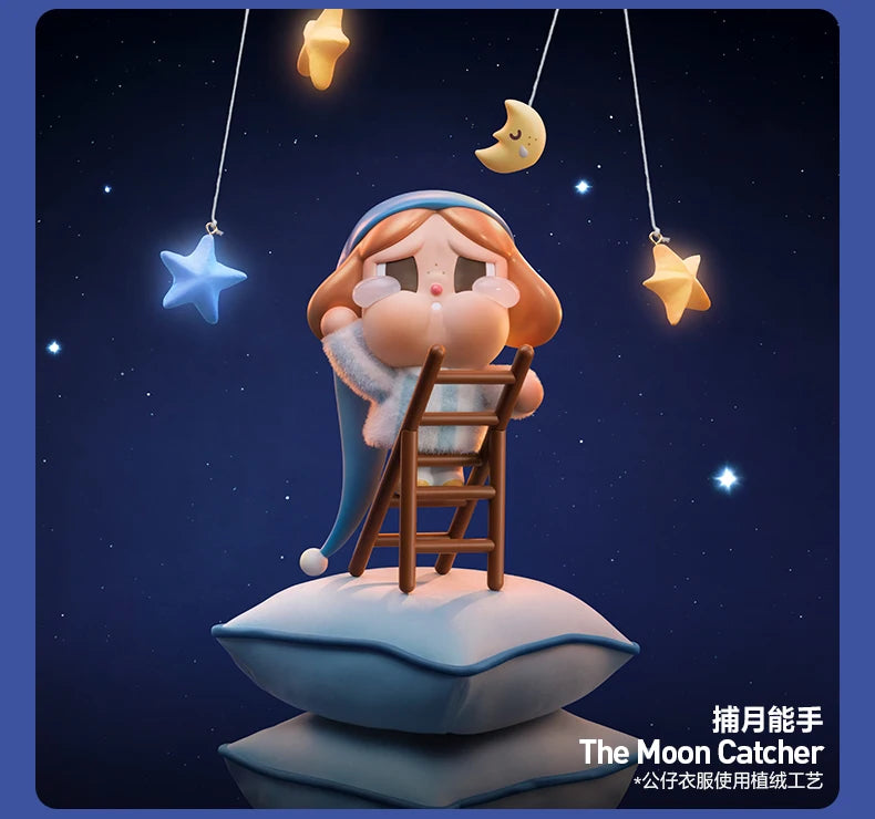 A figurine of a crying girl with blue hair and a blue dress is perched on a cloud, with crescent moon and star charms hanging