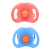 A pair of large silicone feeding bottles in pink and blue with orange centers and attached pacifiers.